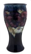 A Moorcroft pottery vase: of waisted form, tube lined in the Pansies pattern in white, blue, red,