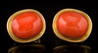 A pair of coral single-stone stud/clip earrings: each cushion shaped coral approximately 16.
