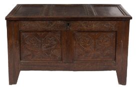 An early 18th Century carved oak rectangular coffer:, with a plain moulded triple panel hinged top,