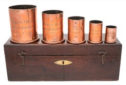A set of five George IV graduated copper wet measures: of plain cylindrical form,