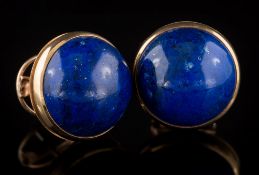 A pair of cabochon circular lapis lazuli single stone ear-studs: each lapis lazuli approximately