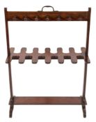 An early 19th Century mahogany riding boot and whip rack:, with central carrying handle,
