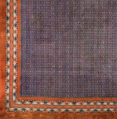 A Turkish carpet:, the indigo lattice field with all over cruciform medallions,