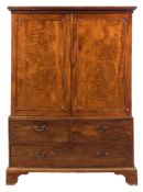 A George III mahogany linen press:, the upper part with a moulded dentil cornice,