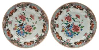 A pair of Chinese famille rose plates: each painted in bright colours with a bird,