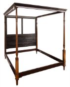 A 19th Century carved mahogany four poster bed: with a moulded dentil and foliate decorated cornice