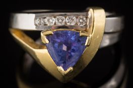 A tanzanite and diamond ring: with a central triangular tanzanite 6.