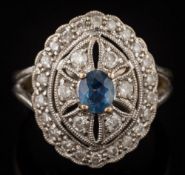 A modern 18ct white gold, sapphire and diamond oval cluster ring: with central oval sapphire 4.