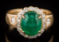 A cabochon emerald and diamond oval cluster ring: the oval cabochon emerald approximately 10.