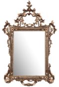 A carved wood and silvered Italianate mirror:, with pierced cartouche,