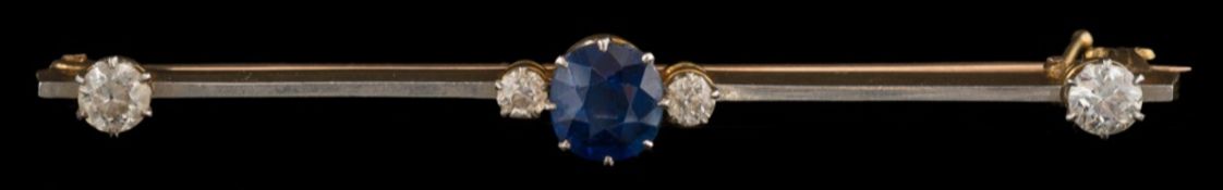 A sapphire and diamond mounted bar brooch: the cushion shaped sapphire approximately 6mm long x 5.