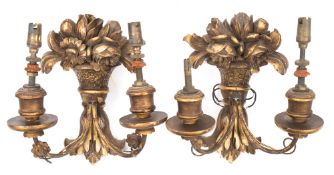 A pair of Continental carved giltwood wall lights: each backplate in the form of a basket of