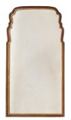 A Queen Anne walnut and partly gilt mirror:, of cartouche outline,