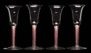 A set of four Dutch colour twist wine glasses: each bell shaped bowl set on a straight double