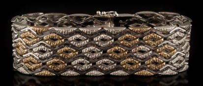 A two-colour 9ct gold bracelet: of textured and polished linking, approximately 19cm long, 43.