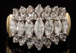 A diamond cluster ring: with central row of graduated,