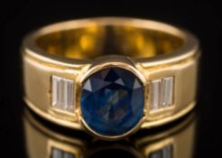 A sapphire and diamond five-stone ring: centring an oval sapphire approximately 8.