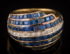 A sapphire and diamond domed cluster ring: set with calibre-cut sapphires and centring a single row
