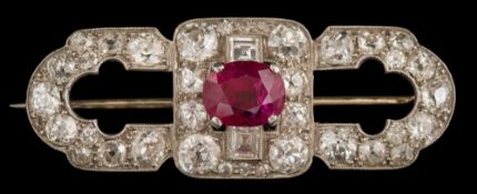 A white metal, ruby and diamond oblong brooch: with central single,