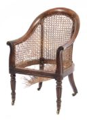 A Regency carved rosewood bergere armchair: with reeded and anthemion decoration,