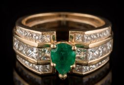 An emerald and diamond mounted ring: with central pear-shaped emerald claw-set between bands of