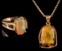 A yellow metal and irregular jelly opal,