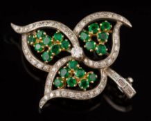 An emerald and diamond spray leaf brooch: pave-set with single-cut diamonds and circular emerald