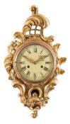 A carved giltwood cartel wall clock: of cartouche-shaped outline with pierced lattice,