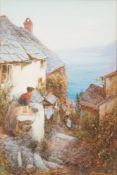 John White [1851-1933]- Coastal cottages on a cliff; a figure washing clothes in the foreground,