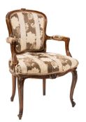 A carved beechwood fauteuil in the Louis XV taste:,