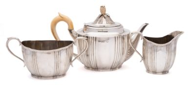 A Victorian matched silver three-piece tea service, various makers, London, 1882,