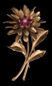 A ruby and diamond mounted 'flower' brooch: with oval-cut rubies and a single old-cut diamond,
