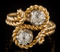 A diamond mounted two-stone cross-over ring: with round old,