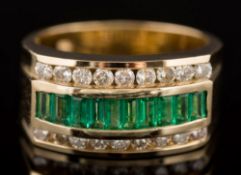 An emerald and diamond three-row cluster ring: with central row of baguette-cut emeralds,