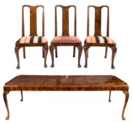 A walnut veneer extending dining table and set of twelve dining chairs in the George I taste:,