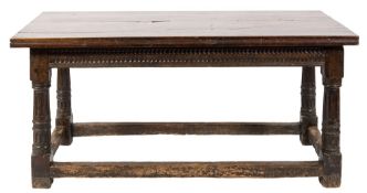 A 17th century oak dining table of refectory type:, with an adapted plank top,