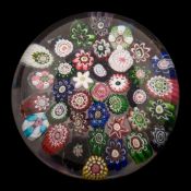 A Clichy close packed millefiori paperweight: set with a variety of coloured canes around a central