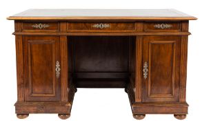 A late 19th/early 20th Century French walnut kneehole desk:,
