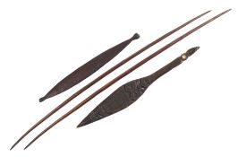 A Maori hardwood and mother-of-pearl inlaid paddle: the blade with carved mask and geometric