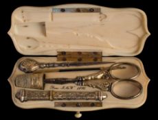 A Victorian ivory etui: of cartouche -shaped outline, bearing initials,