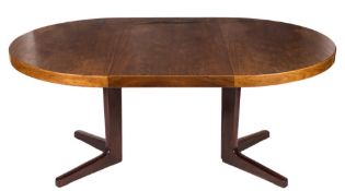 A 1960's teak and rosewood circular extending dining table:, on a central cruciform column and base,
