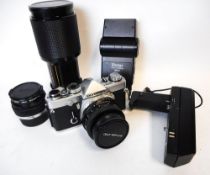 An Olympus OM-1 MD,35mm camera,: with wide angle lens, telephoto lens, standard lens, camera grip,