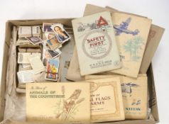 A collection of sets and part sets of cigarette cards in albums and loose:, Players, Wills etc.