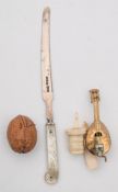 A 19th century gilt metal novelty tape measure in the form of a mandolin:,
