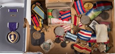 A collection of WWII and later service medals:, including a cased US Purple Heart,