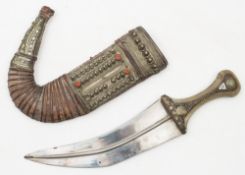 A Jambiyah in scabbard:, of traditional form,