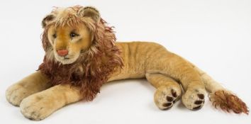 A Steiff blonde plush recumbent 'Leo' lion:, glass eyes, stitched nose and mouth,
