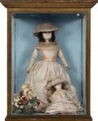 A late 19th century wax doll,: applied black wig,