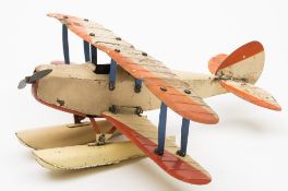 A Meccano No. 0 Aeroplane in cream and red, built as a seaplane: 26cm long.