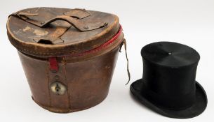 A black felt top hat by the City Cork Hat Company, London:, in a brown leather hat box,